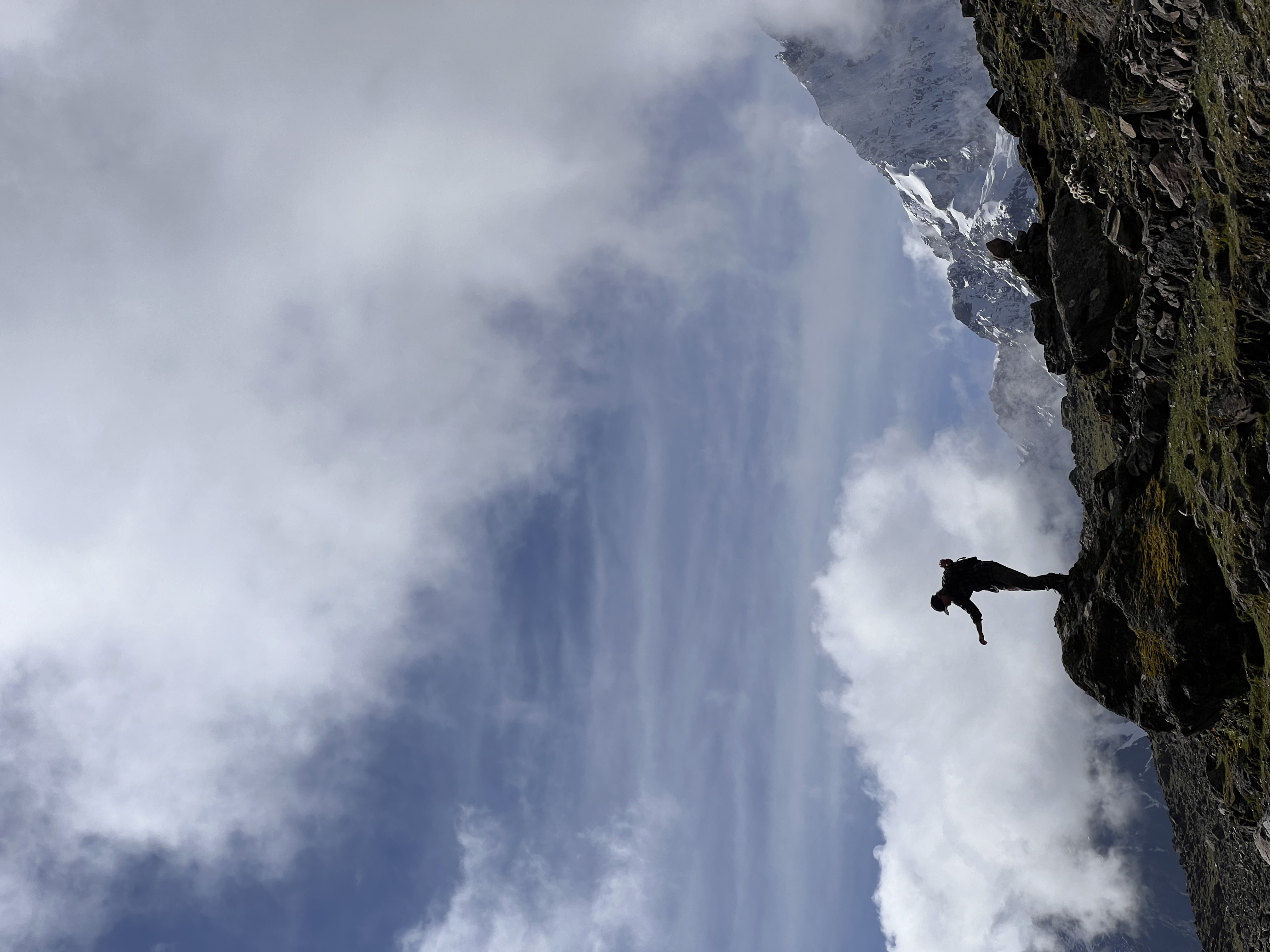 Kasper on a rock above the clouds, Ausangate, Peru