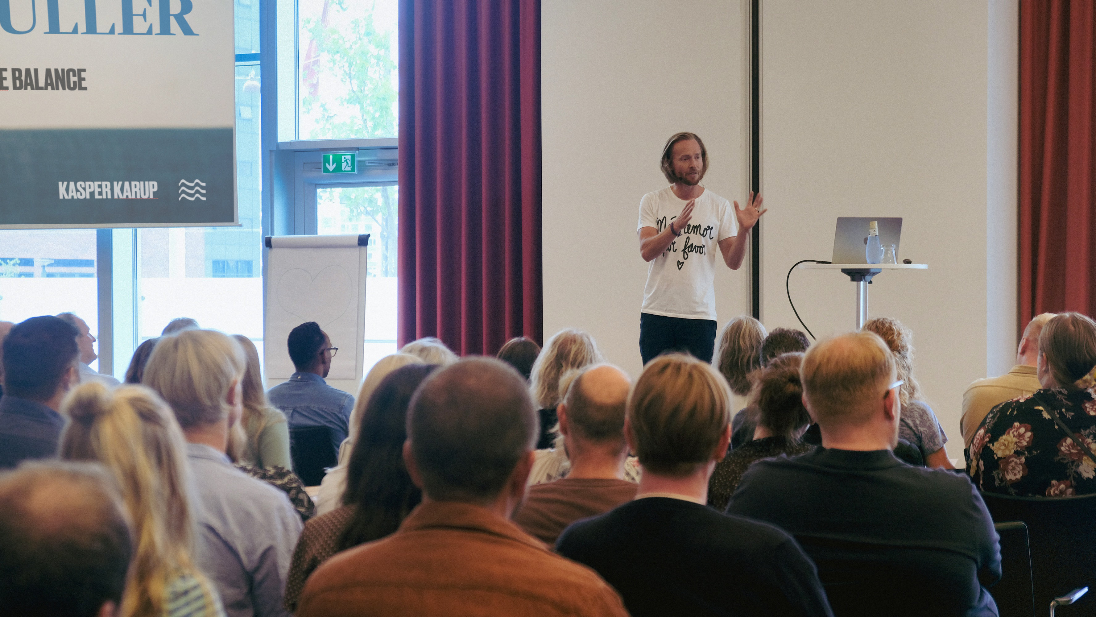 A full room during a session, ICE / WATER / FIRE on the screens